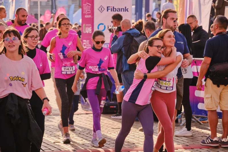 Two participants embracing beside the event barriers.