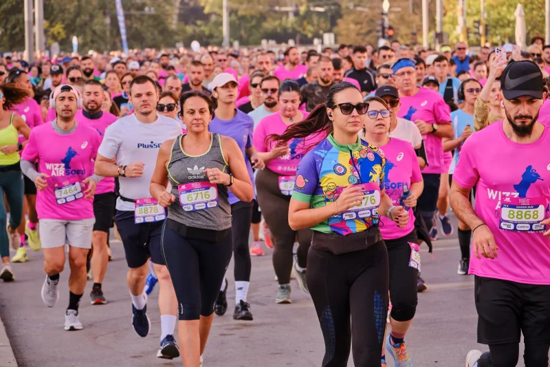 A participant in a colourful patterned shirt among the approaching runners.