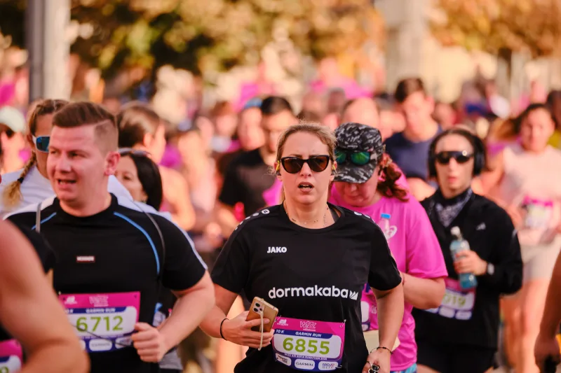 Two runners in black shirts approaching side by side.